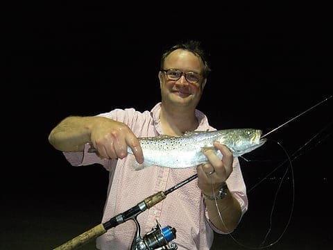 Jason Wood holds a nice trout caught under the lights at Redfish Lodge last night. Photo by Craig Nyhus, LSON. DSCN1758