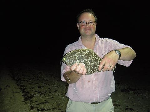 Jason Wood completes his Texas Slam with a nice flounder before midnight. Photo by Craig Nyhus, LSON. DSCN1760