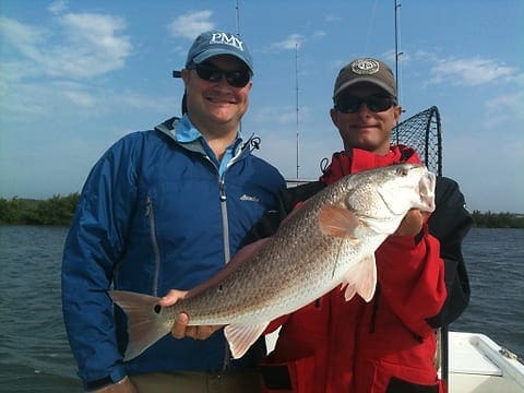 New York angler Jason Wood, left, and Darrell Walker of Overboard Adventures hold a nice red caught this morning near Rockport. Photo by Craig Nyhus, LSON. IMG 0533