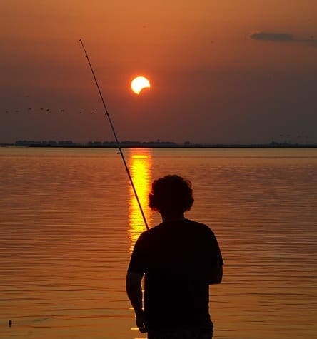SOLAR SHOT: This fisherman witnessed a rare sight, fishing under a solar eclipse. Photo by Billy Hill, g-townsurf.com zsubweb