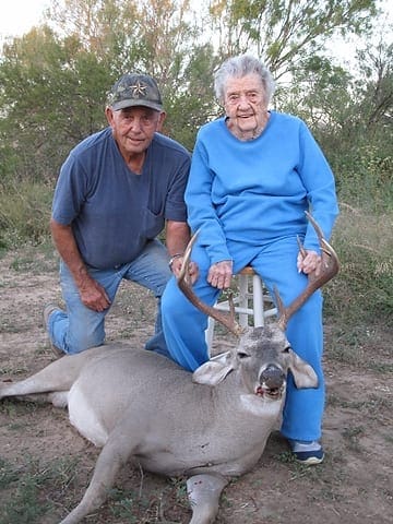 THIS YEAR'S BUCK: Mary and her son, George, show off this year's buck. Photo by Robert Hundley III. 100-yo2