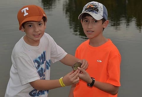 READY FOR THE WEIGH-IN: Two young anglers hold a nice bluegill. Photo by TFFC. aabluetourney2